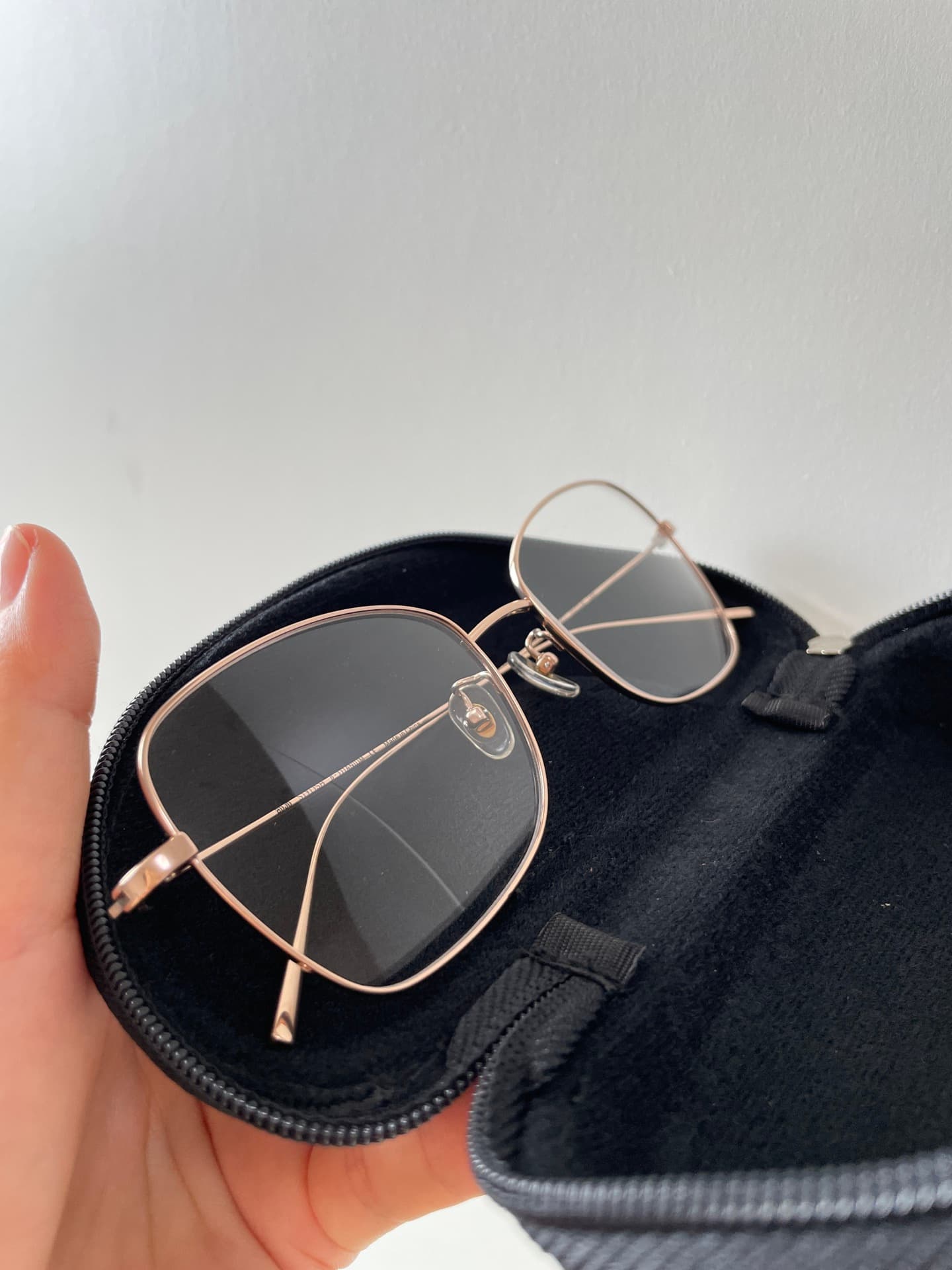 Rose gold square eyeglasses in their case
