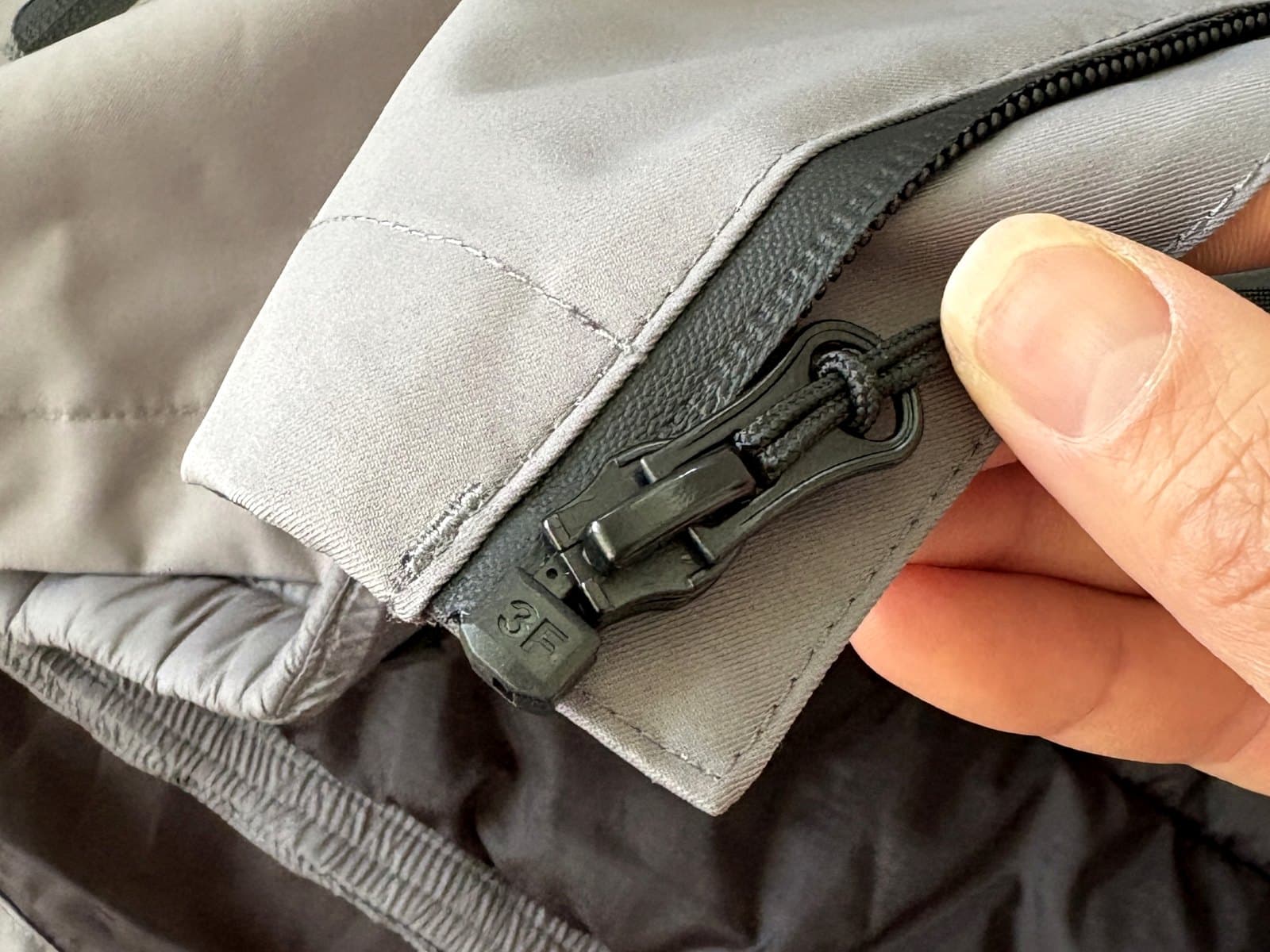 Close-up of the upgraded zipper pull on the jacket